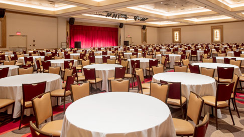an event setup with round tables and stage