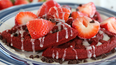 red velvet waffles with strawberries and mini chocolate chips